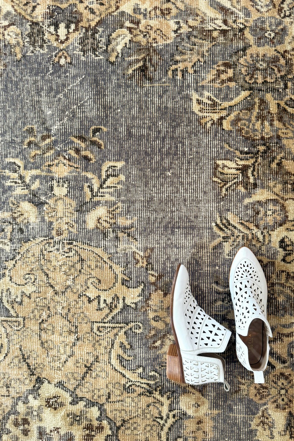 'Diggs' Vintage Turkish Rug - 5'8" x 9'6" - Canary Lane
Close up of a vintage handwoven Turkish area rug with an intricate medallion and warm tones. Features floral designs in lavender, cream, and tan. A timeless piece that adds character and heritage to any space.