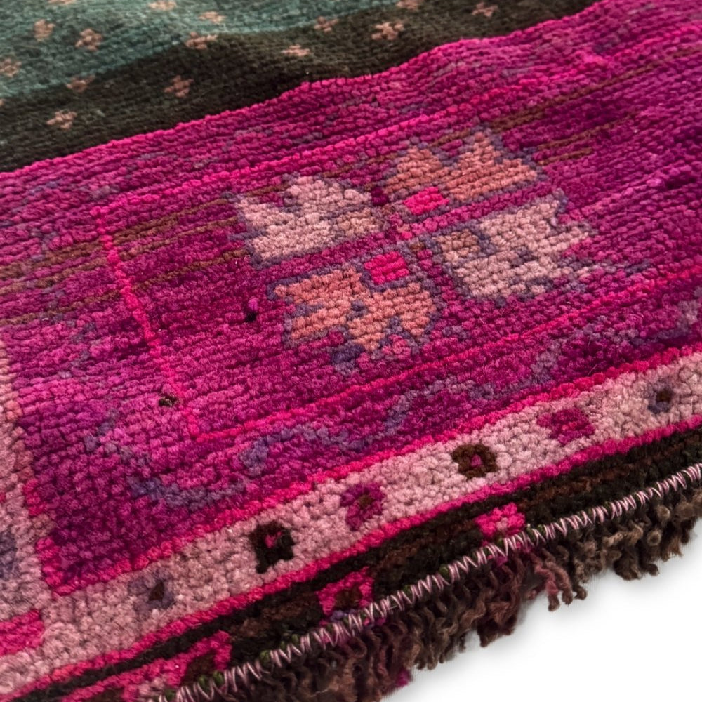 
                  
                    'Foster' Vintage Turkish Runner - 2'5" x 9'9" - Canary Lane
Close up of a vintage handwoven Turkish runner with intricate patterns and rich textures. Features traditional designs in purple, deep sangria, teal, pink, brown, and blue, blending warm and cool tones. Has neatly fringed edges.
                  
                