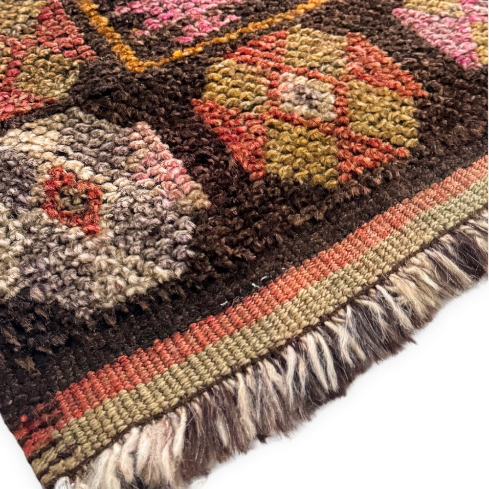 
                  
                    'Milford' Vintage Turkish Runner - 2'11.5" x 12'1" - Canary Lane
Close up of a vintage handwoven Turkish runner featuring an intricate diamond pattern and rich textures. The design showcases traditional craftsmanship and detailed motifs. The color palette includes brown, red, orange, pink, yellow, and gray, creating a harmonious blend of warm and cool tones. The border is detailed with tri-color stripes and a neutral fringe.
                  
                
