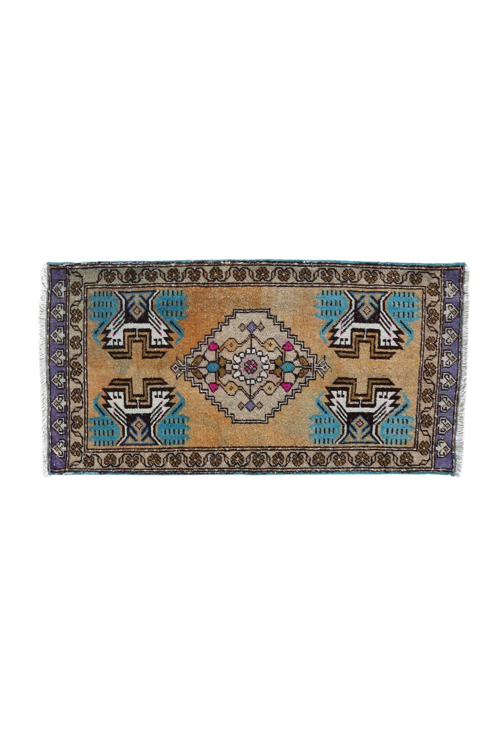 No. 1660 Mini Turkish Vintage Rug - 1'7.5" x 3'2.5" - Canary Lane
A hand woven, vintage rug with a golden peach background and symmetrical geometric design. The central medallion featured intricate patterns in cream, purple, and pink, surrounded by teal and brown accents. Each corner displays bold turquoise and black motifs, and the border includes detailed floral and geometric designs in purple, cream, and brown tones. The rug is neatly finished with fringed edges on both ends. 